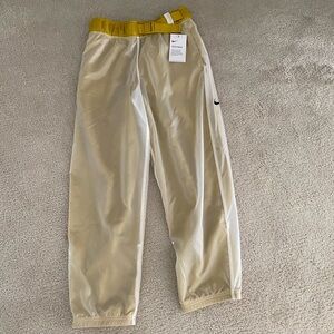 Nike Tech Pack Pants. Cream with Gold accent and side pockets.